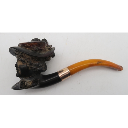 403 - A leather-cased 9ct gold-collared amber-handled Meerschaum pipe, with bowl modelled as an Edwardian ... 