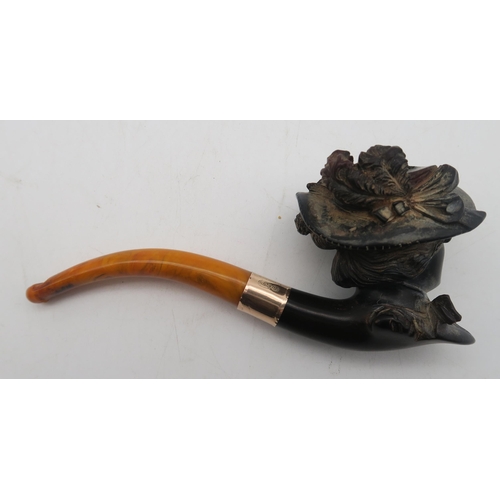 403 - A leather-cased 9ct gold-collared amber-handled Meerschaum pipe, with bowl modelled as an Edwardian ... 