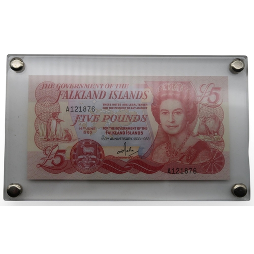 364 - A world wide collection of banknotes in three albums together with A Falklands Islands £5 1983... 