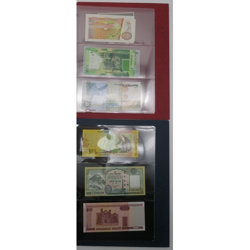 364 - A world wide collection of banknotes in three albums together with A Falklands Islands £5 1983... 