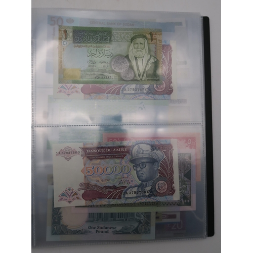 364 - A world wide collection of banknotes in three albums together with A Falklands Islands £5 1983... 