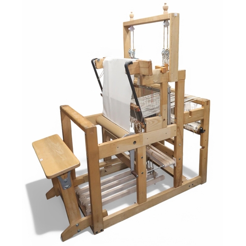 6105 - A large floor standing weaving loom and stool