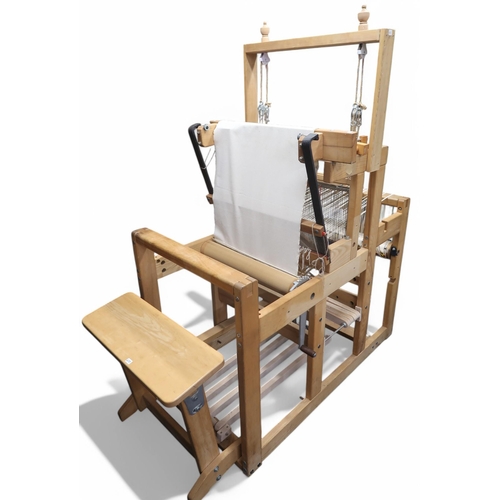 6105 - A large floor standing weaving loom and stool