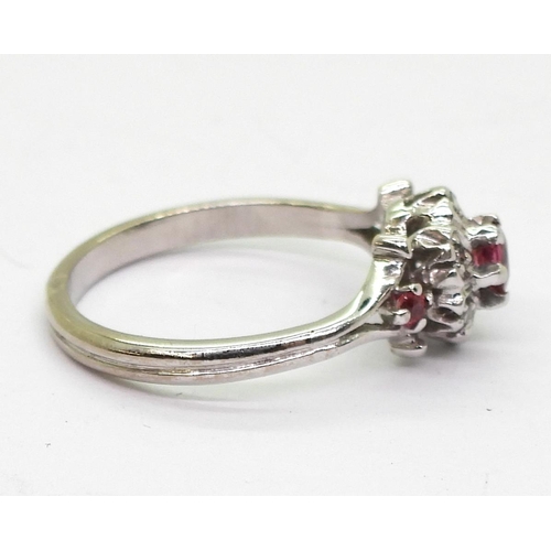 702 - An unusual 18ct white gold ruby and diamond flower ring, size K1/2, weight 3gms