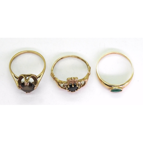 730 - Three 9ct gold rings, a smoky quartz size N1/2, Claddagh set with a sapphire, size O1/2, and a green... 