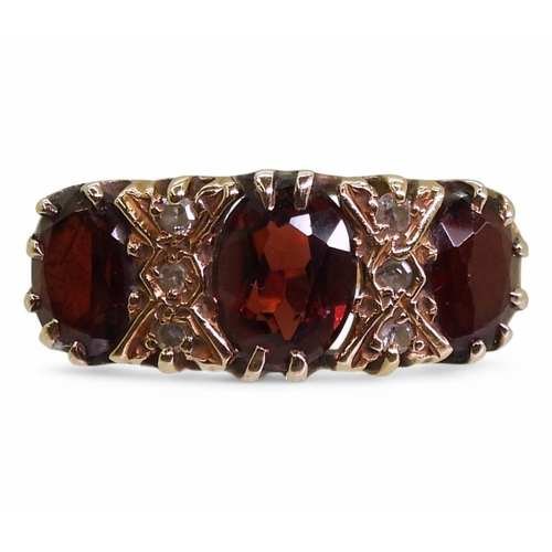 732 - An 18ct gold garnet and diamond three stone ring, size approx K, weight 5gms