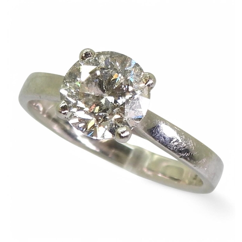 742 - A platinum ring set with a diamond solitaire, of estimated approx 1.75cts, in a four claw cross over... 