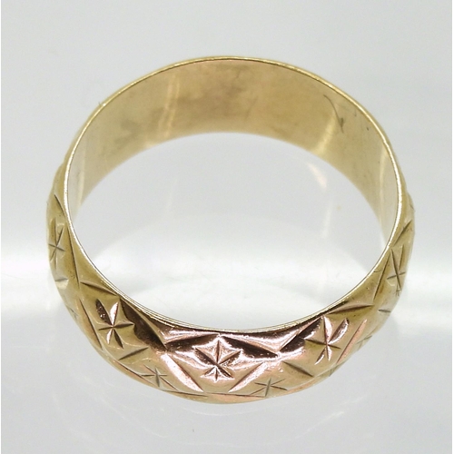 745 - A 9ct gold retro star engraved wedding ring, size  O1/2, hallmarked London 1974, weight 3.8gms