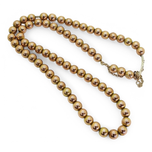 752 - A 9ct gold string of beads, with a hidden box clasp, weight 18.7gms