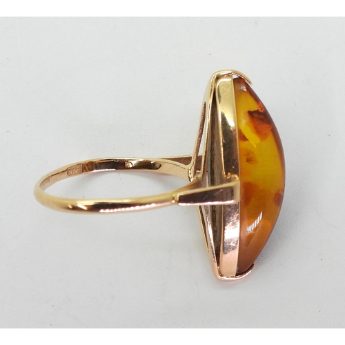 761 - A Russian amber dress ring, stamped with Hammer & sickle marks and stamped with the metal purity... 