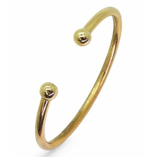 765 - A 9ct gold torc style bangle, weight 19.4gms