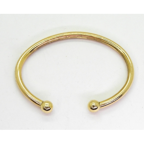 765 - A 9ct gold torc style bangle, weight 19.4gms