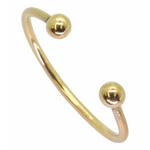 767 - A gents yellow metal torc style bangle, inner diameter approx 7cm, weight 51.5gms