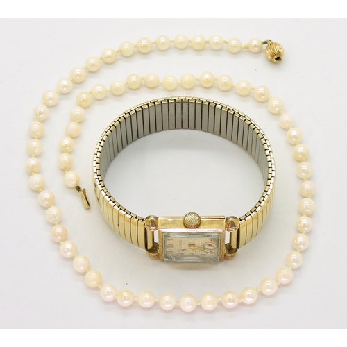 769 - A ladies '10k rolled gold plate' Bulova watch together with a string of cultured pearls with a 9ct g... 