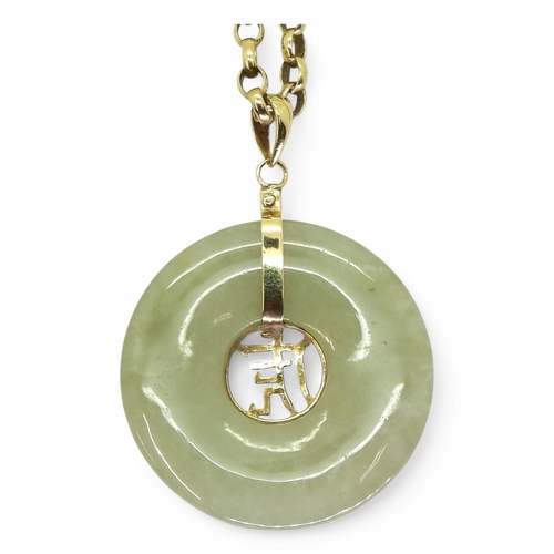 791 - A Chinese green hardstone rondel pendant with a symbol and bright yellow metal mount, on a 66cm 9ct ... 