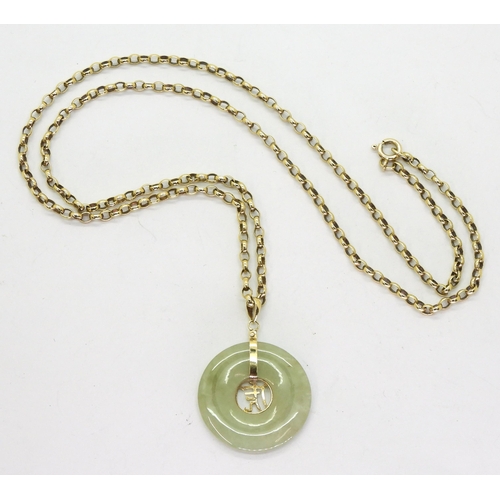 791 - A Chinese green hardstone rondel pendant with a symbol and bright yellow metal mount, on a 66cm 9ct ... 