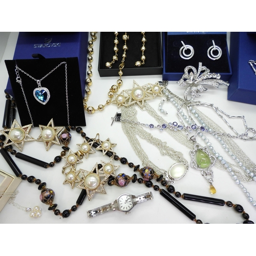 865 - A collection of costume jewellery to include items by Swarovski in original boxes, Butler & Wils... 