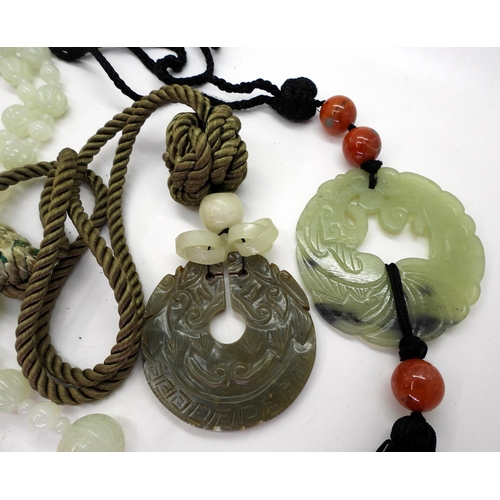 870 - A collection of Chinese green hardstone to include;- a string of pale green beads carved with symbol... 