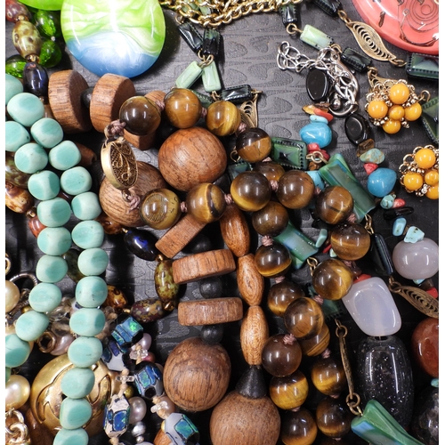 874 - A large collection of vintage costume jewellery to include;- a string of tiger's eye beads, a string... 