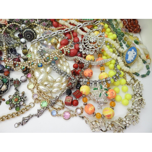 882 - A large collection of vintage costume jewellery to include beads, diamante necklaces, a metal studde... 