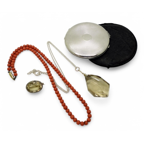 887 - A silver compact with Birmingham hallmarks for 1941, a string of coral beads with a 9ct gold clasp, ... 