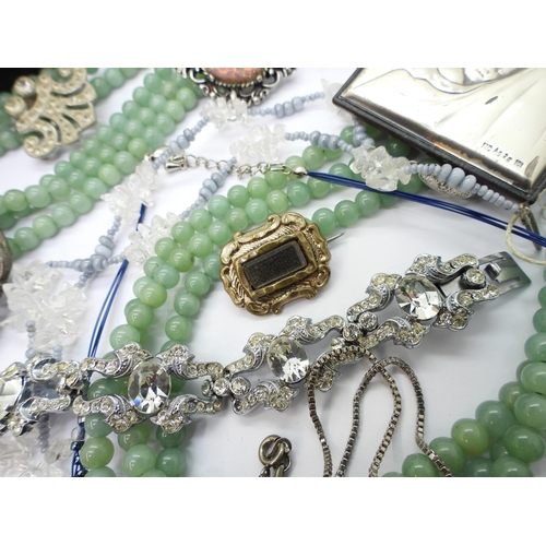 891 - A triple string of Chinese green hardstone beads, a white metal Austro Hungarian George & The Dr... 