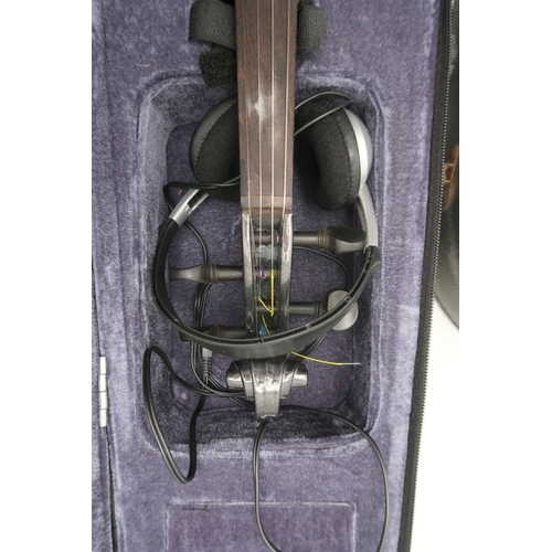 385 - A modern 'S' shaped electric violin, with a bow, a fitted case, leads, headphones and spare strings.... 