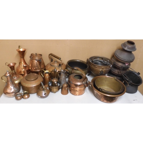 100 - A large mixed lot of assorted brass, copper and other metal wares to include cauldrons, kettles, ewe... 