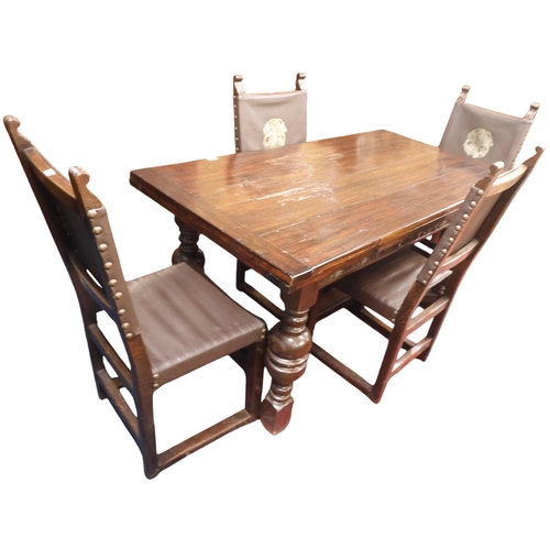 11 - A 20th century stained elm extending dining table and four chairs, table with rectangular pull out t... 