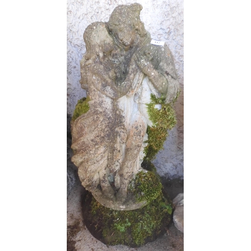 117 - A 20th century reconstituted stone figural garden statue depicting classical male and female in embr... 