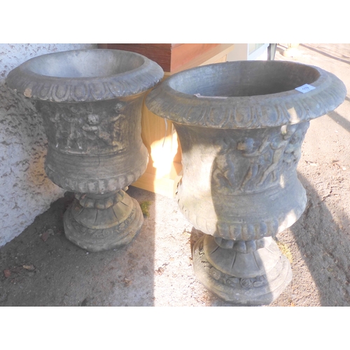 119 - A pair of 20th century stoneware garden urns cast with classical scenes on pedestal bases, 68cm high... 