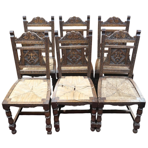 12 - A set of six 19th century oak baronial style dining chairs with decorative splat carved with green m... 