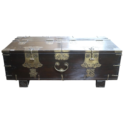 21 - An early 20th century Chinese brass banded hardwood rice chest with pair of hinged lids on block sup... 