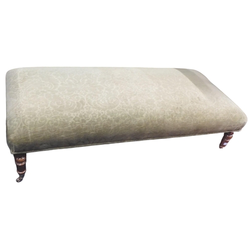 28 - A contemporary green damask upholstered Ottoman footstool on turned supports terminating in brass ca... 