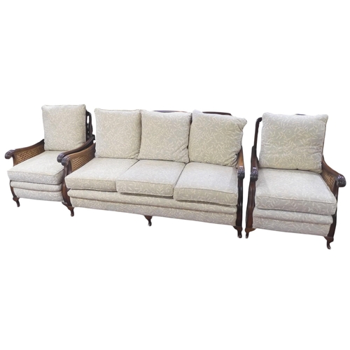 32 - A late 20th century mahogany framed three piece bergere suite consisting three seater settee, 84cm h... 