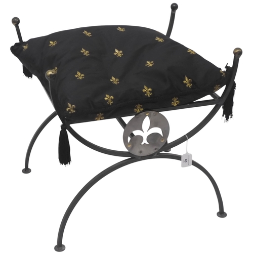 40 - A contemporary Richard Pell steel and brass stool with loose cushion over fleur de lis motif on cros... 