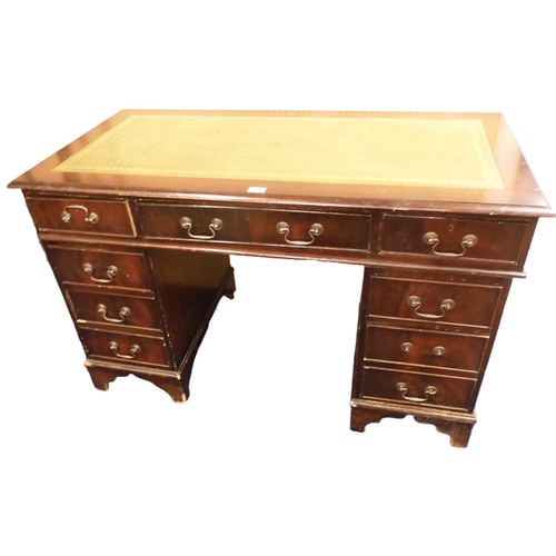 71 - A 20th century mahogany pedestal desk with green skiver top over long central drawer on twinned pede... 