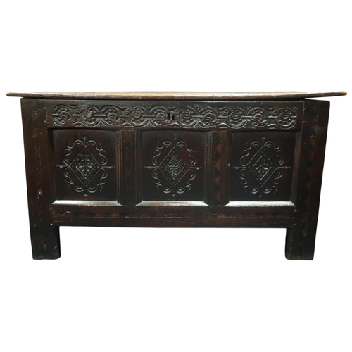 89 - A 17th/18th century oak panelled blanket chest with decoratively carved front panels, 61cm high x 11... 