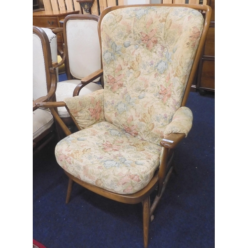 93 - A mid to late 20th century Ercol elm and beech rail back armchair with floral upholstered cushions, ... 