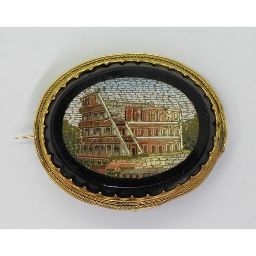 2719 - A MICRO MOSAIC BROOCHdepicting the Colosseum, in a yellow metal brooch mount, the pin is stamped wit... 