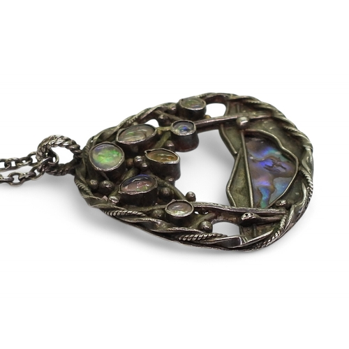 2724 - AN ARTS & CRAFTS STYLE COLLECTIONa white metal paua shell pendant set with jelly opals, length 4... 