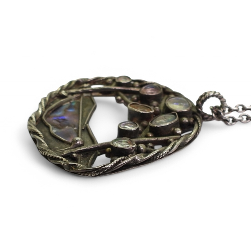 2724 - AN ARTS & CRAFTS STYLE COLLECTIONa white metal paua shell pendant set with jelly opals, length 4... 