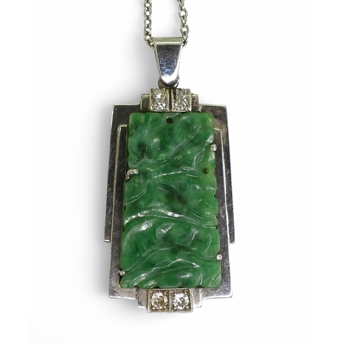 2729 - AN ART DECO PENDANT set with four diamonds and a carved green hardstone panel, length including the ... 