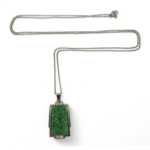 2729 - AN ART DECO PENDANT set with four diamonds and a carved green hardstone panel, length including the ... 