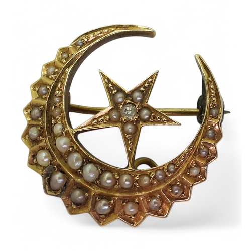 2730 - A CRESCENT MOON BROOCHstamped 18, and set with a diamond and pearls, diameter 2.5cm, weight 4.6gms... 