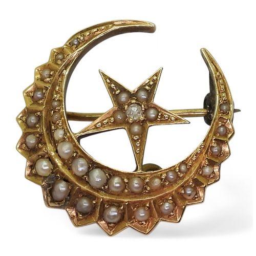 2730 - A CRESCENT MOON BROOCHstamped 18, and set with a diamond and pearls, diameter 2.5cm, weight 4.6gms... 