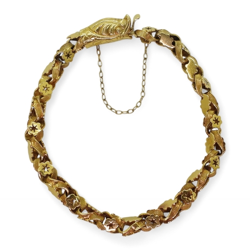 2736 - A SNAKE BRACELETwith decorative leaf and flower links and a box clasp made in bright yellow metal. L... 