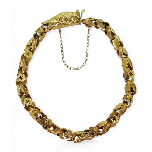 2736 - A SNAKE BRACELETwith decorative leaf and flower links and a box clasp made in bright yellow metal. L... 