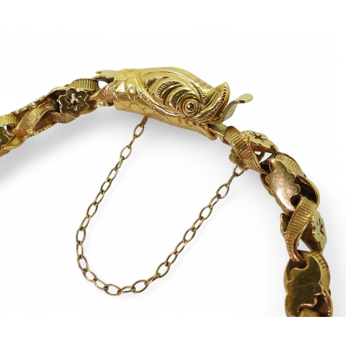 2736 - A SNAKE BRACELETwith decorative leaf and flower links and a box clasp made in bright yellow metal. L... 