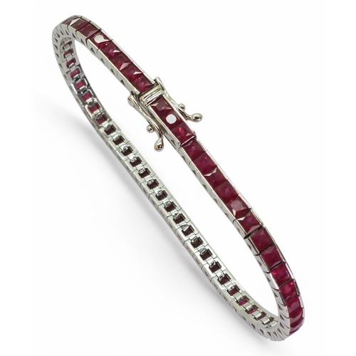 2746 - RUBY LINE BRACELETset with fifty seven square cut rubies in tension settings, the mount in 18ct whit... 